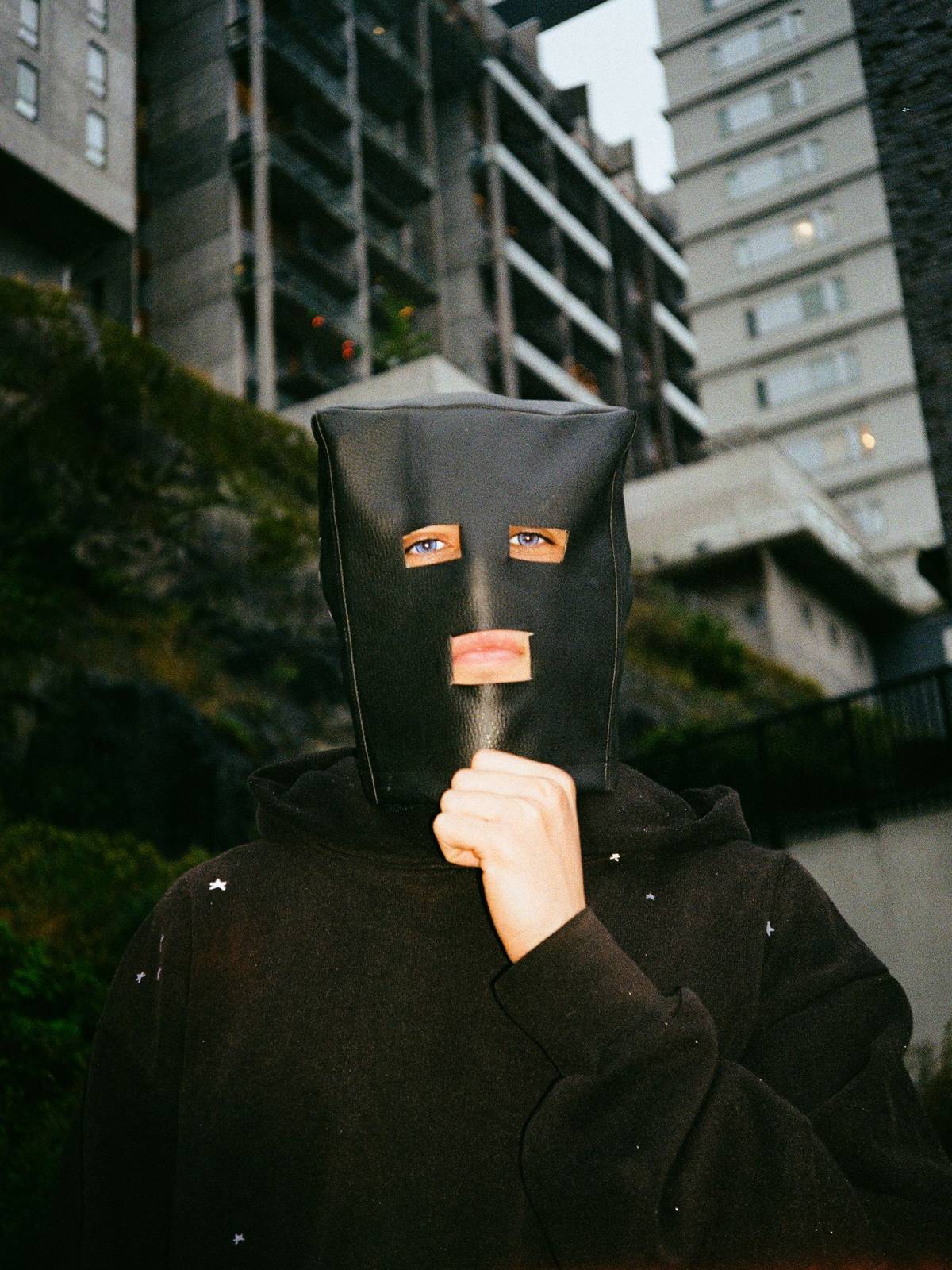 LOAM in a black leather mask and black hoodie
